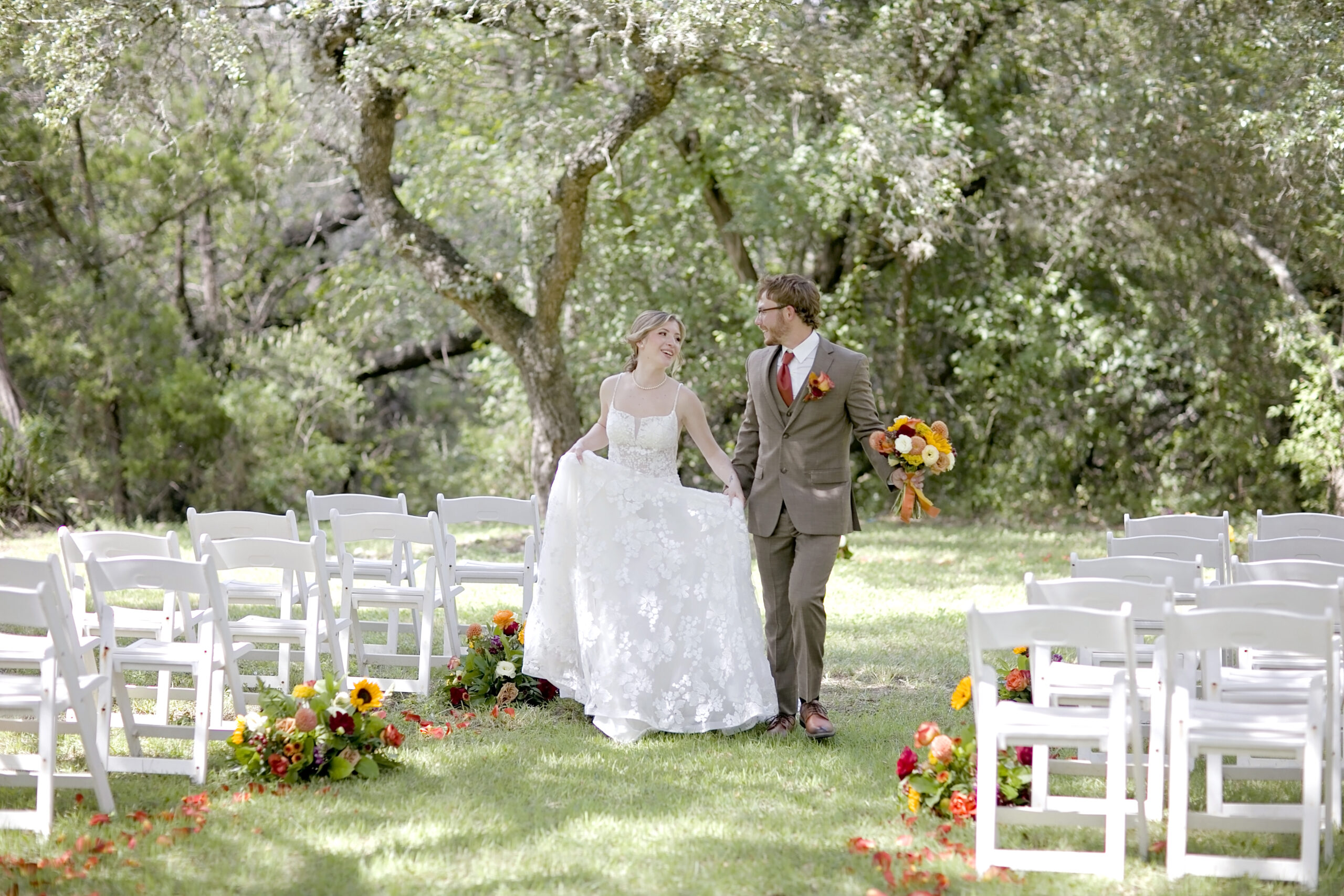 Fall rustic styled wedding at Garden at Old Town Helotes in San Antonio, Texas, featuring mustard, rust, and burgundy décor, flower-petal-lined aisle, and elegant lounge setup by top local vendors.