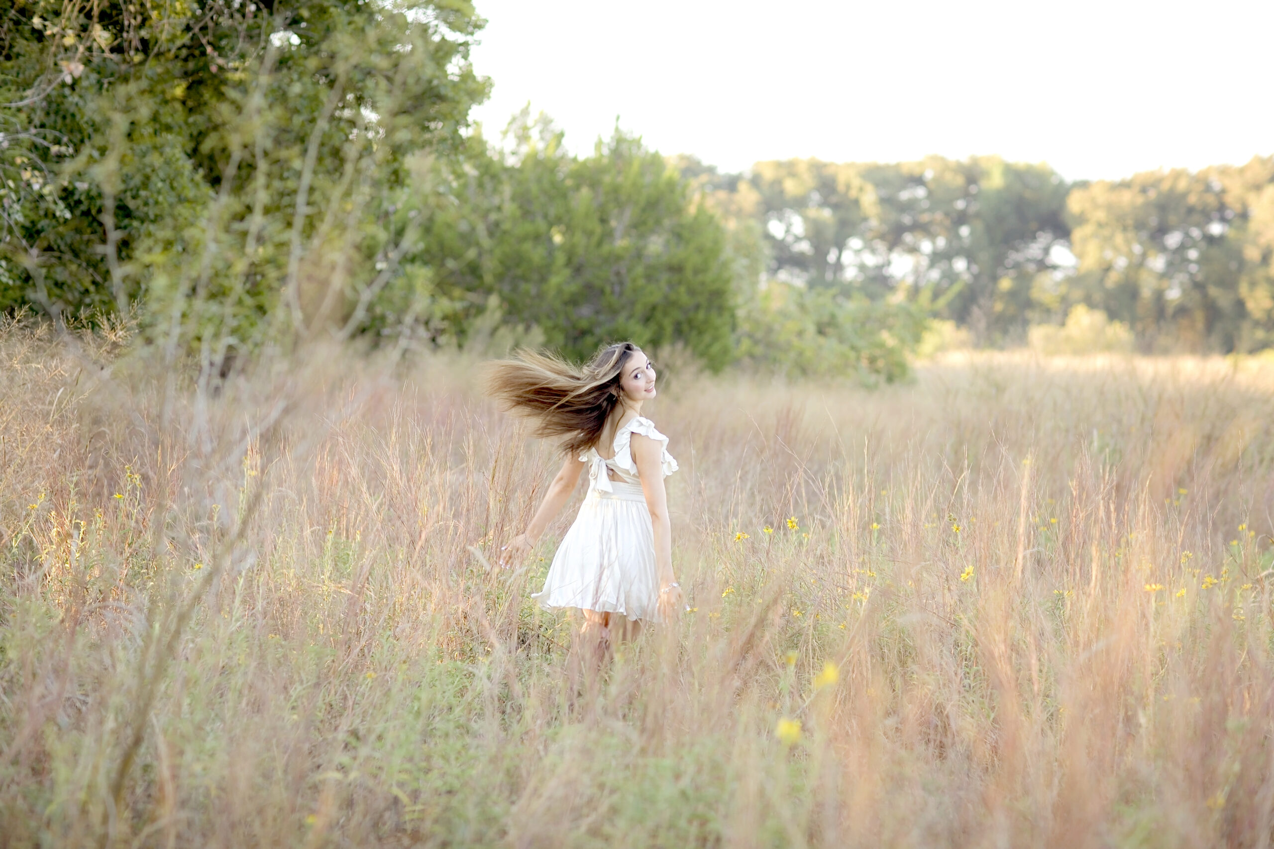 Senior portraits of Mya at Cibolo Conservation in Boerne, Texas, captured by San Antonio photographer Robin Rogers in bright, natural fall light.