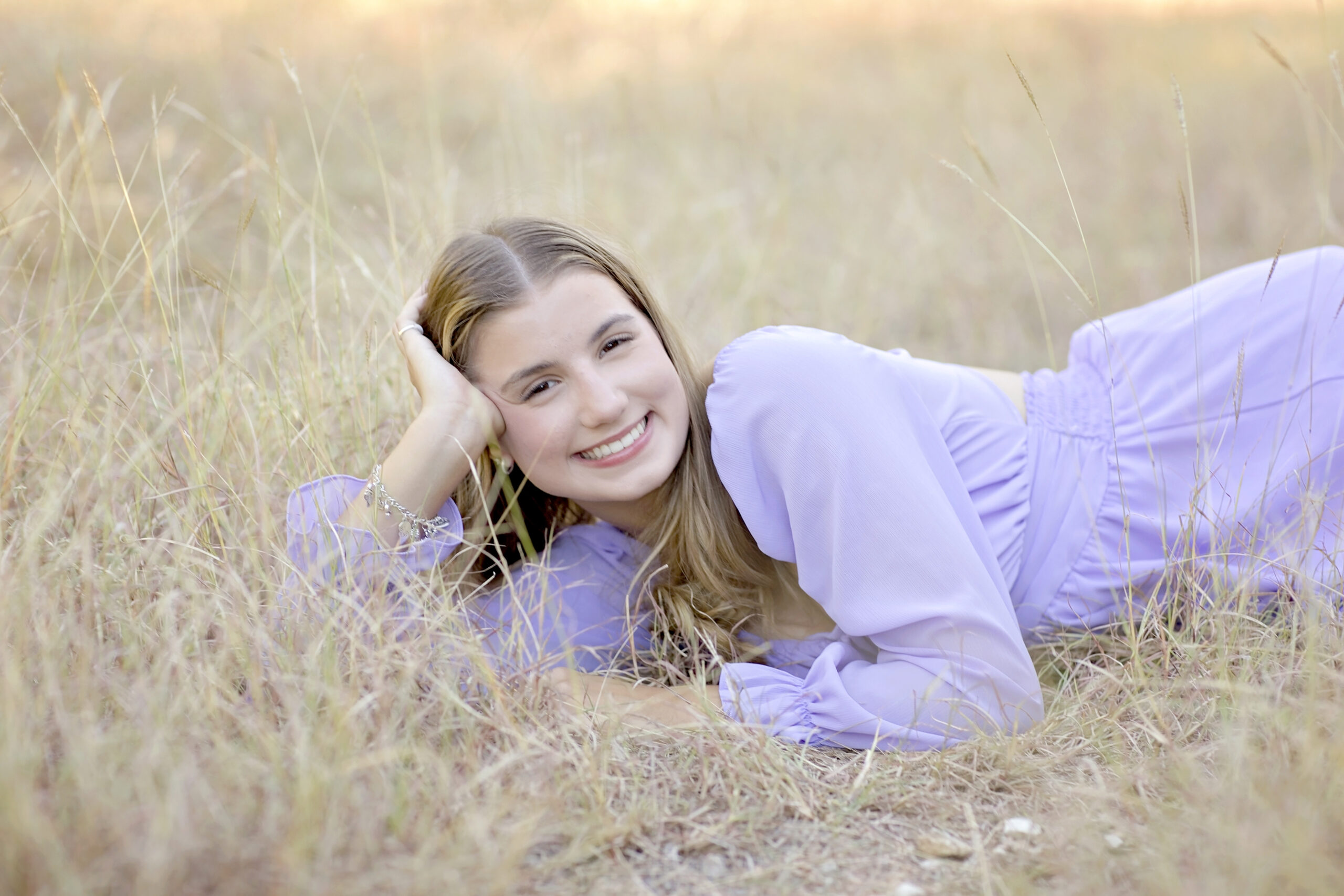 Savanna’s Class of 2026 senior portraits at Government Canyon in San Antonio, Texas, featuring fall outdoor scenery, white and lavender dresses, her playful pup cameo, and a heartfelt family moment with her mom.