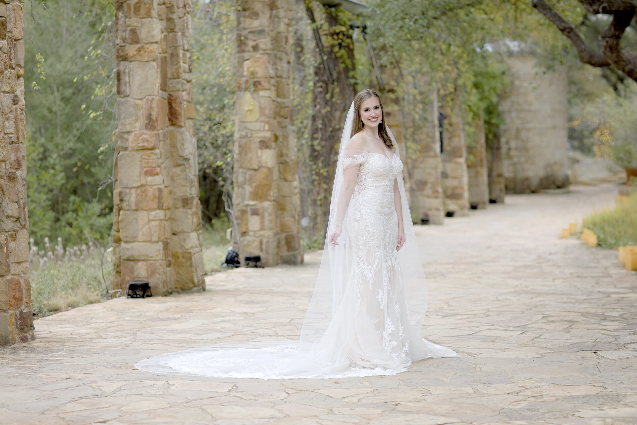 San Antonio bridal session featuring Rachel in a wedding gown at Lady Bird Johnson Wildflower Center with soft rain mist.