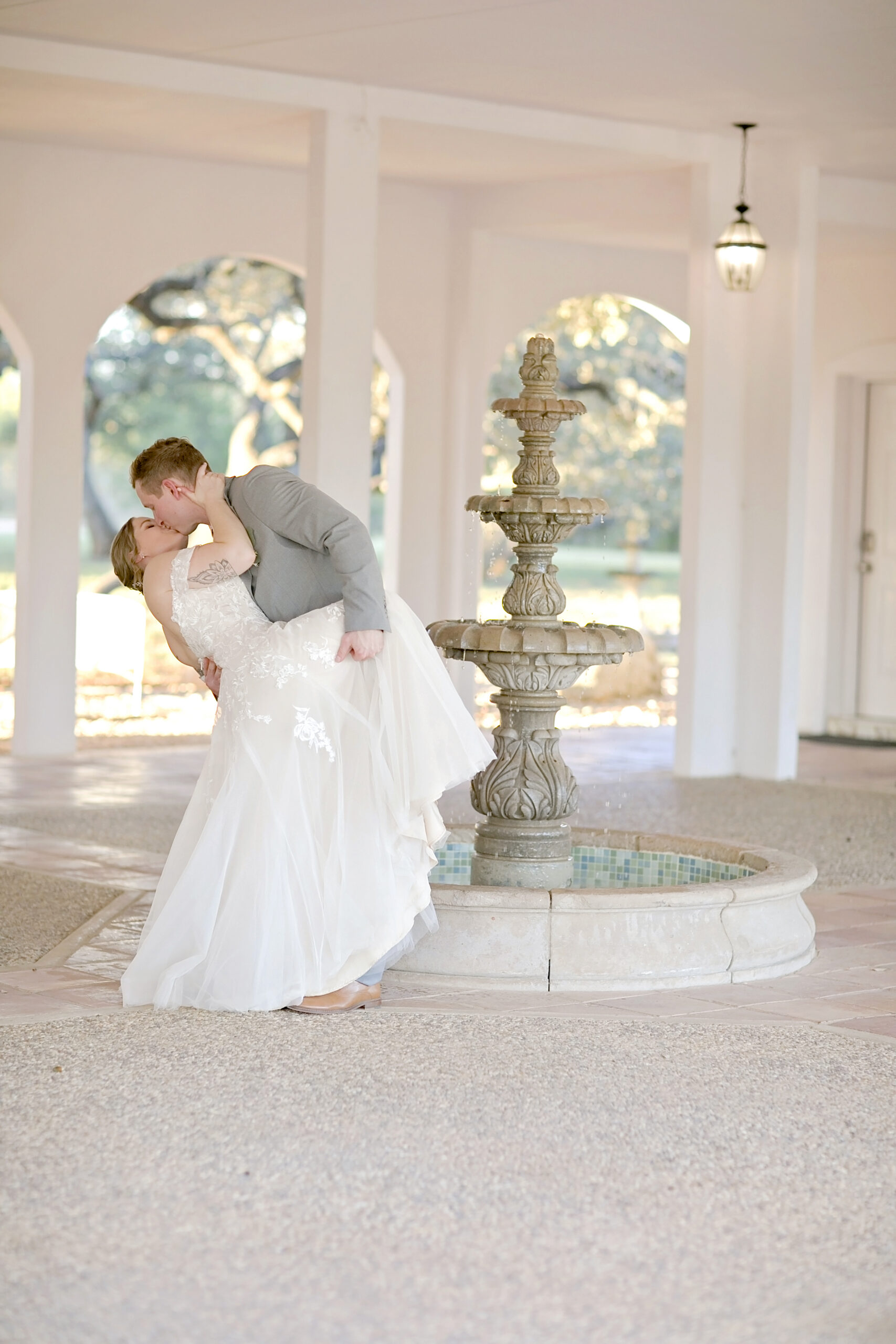 Rylie and Ron, newlyweds, sharing a joyful moment during their intimate wedding at La Dolce Vita in Texas Hill Country, surrounded by family and friends.