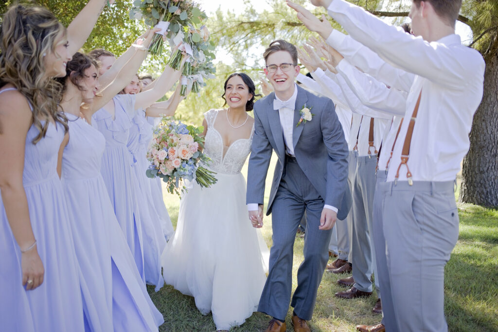 Texas Hill Country wedding couple walking through their wedding party