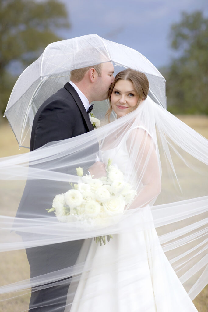 Texas Hill Country wedding couple in the rain Dos Palomos Ranch