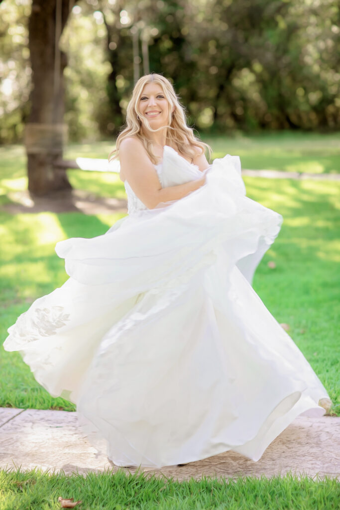 Bride in flowing wedding dress during outdoor bridal portraits