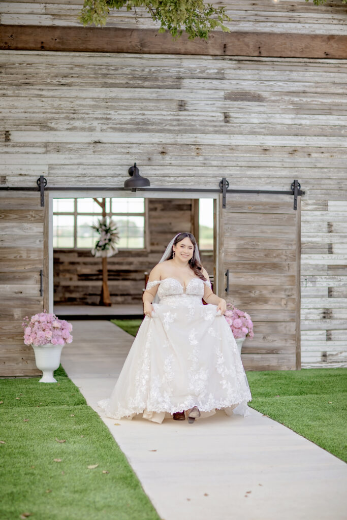 Bride walking through the open-air chapel at The Fields Venue in Boerne, Texas